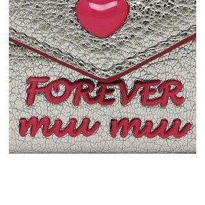 BRAND NEW NEVER USED MIU MIU SILVER METALLIC WALLET WITH FUCHSIA METALLIC TRIM.